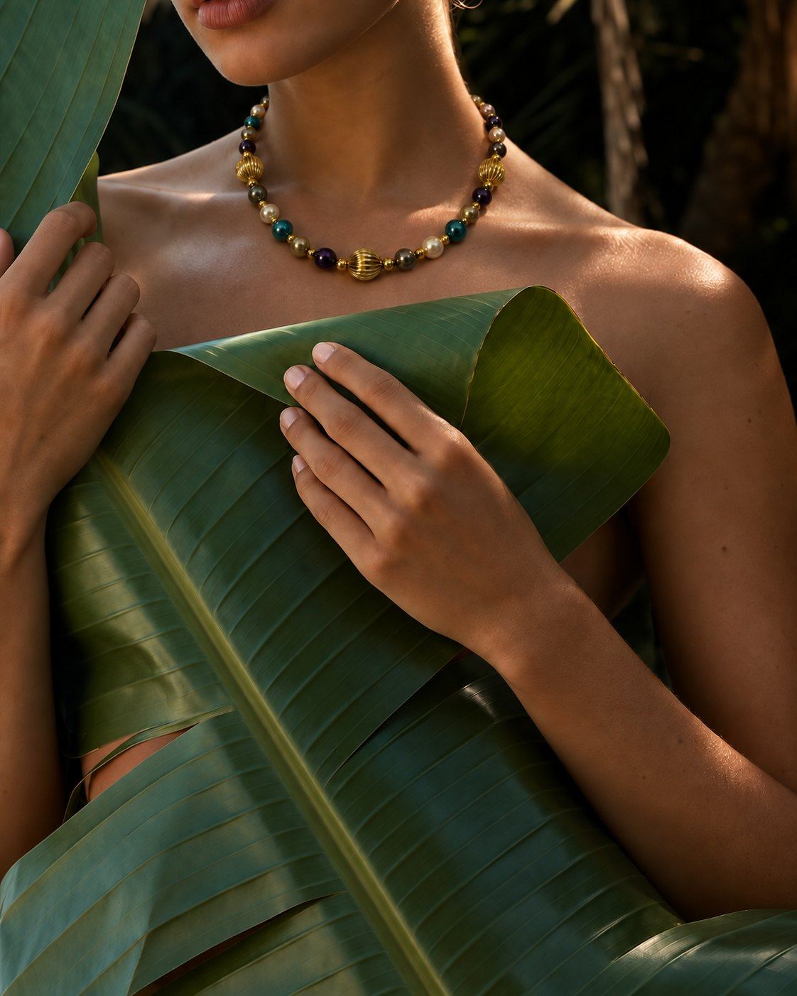 Nanshe necklace worn by a woman holding a large green banana leaf.